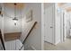 Hallway with wooden stairs, decor, and access to bathroom and other rooms at 2102 S Ocean Blvd. # D, North Myrtle Beach, SC 29582