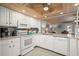 White kitchen with wooden ceilings, modern appliances, granite countertops and tile backsplash at 2102 S Ocean Blvd. # D, North Myrtle Beach, SC 29582