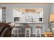 Bright kitchen features white cabinets, a tiled backsplash, granite countertops, and bar seating at 2102 S Ocean Blvd. # D, North Myrtle Beach, SC 29582