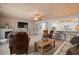 Cozy living room features a fireplace, wood ceiling, and natural light, ideal for relaxing at 2102 S Ocean Blvd. # D, North Myrtle Beach, SC 29582