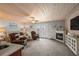 Cozy living room features a fireplace, wood ceiling, and natural light, ideal for relaxing at 2102 S Ocean Blvd. # D, North Myrtle Beach, SC 29582