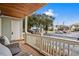 Inviting covered porch featuring comfortable seating, a wood ceiling, and views of the parking area at 2102 S Ocean Blvd. # D, North Myrtle Beach, SC 29582
