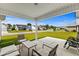 Covered back porch with outdoor seating and views of a well-kept lawn and neighborhood at 224 Fishburn Dr., Conway, SC 29526