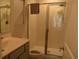 Clean and modern bathroom featuring a glass-enclosed shower, a vanity with double sinks, and tiled floors at 224 Fishburn Dr., Conway, SC 29526