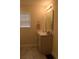 Well-lit bathroom with a single sink vanity, tiled floors, and a large mirror, offering a clean aesthetic at 224 Fishburn Dr., Conway, SC 29526