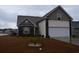 Charming single-Gathering home featuring a two-car garage, landscaped front yard, and a mix of brick and vinyl siding at 224 Fishburn Dr., Conway, SC 29526