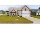 Charming front exterior features a manicured lawn and an attached two car garage at 224 Fishburn Dr., Conway, SC 29526