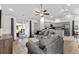 Spacious living room with an open design, gray sofas, and access to the kitchen and outdoor patio at 224 Fishburn Dr., Conway, SC 29526