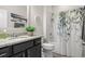 Well-lit bathroom featuring shower with patterned curtain, granite countertop, and decorative accents at 232 Red Maple Loop, Longs, SC 29568