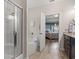 Bathroom featuring a soaking tub with shower, bead curtain, and dark cabinets with granite countertops at 232 Red Maple Loop, Longs, SC 29568