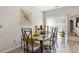 Dining area featuring modern table with glass top, seating for four, and natural light from sliding glass doors at 232 Red Maple Loop, Longs, SC 29568