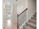 Inviting hallway with hardwood floors, stairs and natural light coming through front door at 232 Red Maple Loop, Longs, SC 29568