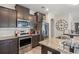 Modern kitchen featuring stainless steel appliances, dark cabinets, and granite counters at 232 Red Maple Loop, Longs, SC 29568