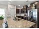 Spacious kitchen with granite counters, stainless steel appliances and dark wood cabinets at 232 Red Maple Loop, Longs, SC 29568