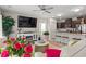 Open-concept living room with a kitchen, with a white sofa, a ceiling fan, and a large TV at 232 Red Maple Loop, Longs, SC 29568