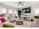 Bright living room featuring a plush white sofa, large windows, and stylish decor at 232 Red Maple Loop, Longs, SC 29568