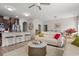 Open-concept living room featuring a modern sofa, stylish coffee table, and breakfast bar with seating at 232 Red Maple Loop, Longs, SC 29568