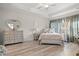 Comfortable main bedroom features trey ceiling, neutral tones, bedside tables and lamps, plus a decorative heart mirror at 232 Red Maple Loop, Longs, SC 29568