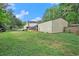 Expansive backyard with a large, detached garage and lush greenery, perfect for outdoor activities at 238 Robin Dr., Georgetown, SC 29440