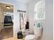 Neutral bathroom with a window, hooks, and white paneling details at 238 Robin Dr., Georgetown, SC 29440
