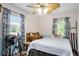 Cozy bedroom with ceiling fan, blue accents, and natural light from two windows at 238 Robin Dr., Georgetown, SC 29440
