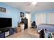 Organized bedroom with TV, dresser, closet, blue walls and laminate floors at 238 Robin Dr., Georgetown, SC 29440