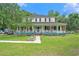 Charming two-story home with a large front porch, blue accents, and a well-manicured lawn at 238 Robin Dr., Georgetown, SC 29440