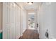 Well-lit hallway with wood floors and white doors leading to a bright bathroom at 238 Robin Dr., Georgetown, SC 29440
