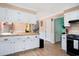 Well-lit kitchen featuring white cabinets, stainless appliances, and hardwood floors at 238 Robin Dr., Georgetown, SC 29440