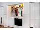Functional laundry closet with washer, dryer, and shelving for storage in this cozy home at 238 Robin Dr., Georgetown, SC 29440
