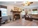 Cozy living room with a brick fireplace, neutral paint, and abundant natural light at 238 Robin Dr., Georgetown, SC 29440