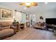 Comfortable living room with a decorative love seat, stylish barn door, and hardwood floors at 238 Robin Dr., Georgetown, SC 29440