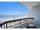 Inviting balcony with seating and views of the sandy beach and sparkling ocean at 2401 S Ocean Blvd. # 557, Myrtle Beach, SC 29577