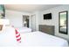 Bright bedroom featuring two beds, a flat-screen TV, and a convenient dresser at 2401 S Ocean Blvd. # 557, Myrtle Beach, SC 29577