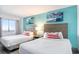 Bright bedroom with two beds, coastal art, and ample natural light at 2401 S Ocean Blvd. # 557, Myrtle Beach, SC 29577