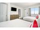 Cozy bedroom with two beds, a flat-screen TV, and a dresser for storage at 2401 S Ocean Blvd. # 557, Myrtle Beach, SC 29577