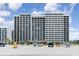 Oceanfront resort with multiple floors, balconies, and palm trees along a sandy beach at 2401 S Ocean Blvd. # 557, Myrtle Beach, SC 29577