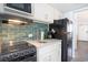 Charming kitchen featuring white countertops, teal backsplash, and modern appliances at 2401 S Ocean Blvd. # 557, Myrtle Beach, SC 29577