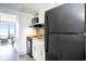 Efficient kitchen with black appliances, white cabinets, and serene views at 2401 S Ocean Blvd. # 557, Myrtle Beach, SC 29577