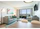 Comfortable living room with sofa and balcony with ocean views in this bright condo at 2401 S Ocean Blvd. # 557, Myrtle Beach, SC 29577