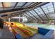 Indoor pool area featuring multiple yellow and orange water slides for Gathering entertainment at 2401 S Ocean Blvd. # 557, Myrtle Beach, SC 29577