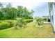 Spacious backyard with a pond view, lush greenery, and a peaceful setting at 251 Juniata Loop, Little River, SC 29566