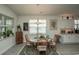 Bright dining area showcasing a wooden table with seating for four and ample natural light at 251 Juniata Loop, Little River, SC 29566