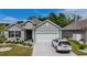 Charming one-story home featuring a two-car garage, well-manicured lawn, and attractive gray siding at 251 Juniata Loop, Little River, SC 29566