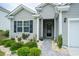 Inviting front entrance with a walkway, landscaping, and stylish front door at 251 Juniata Loop, Little River, SC 29566