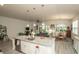 Open concept kitchen with granite countertops, stainless steel appliances, and adjacent living and dining areas at 251 Juniata Loop, Little River, SC 29566