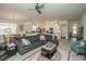 Spacious living room with light gray flooring, a comfortable sofa, and open access to the kitchen and dining area at 251 Juniata Loop, Little River, SC 29566