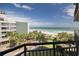 Beautiful ocean view from balcony featuring palm trees, sandy beach and walking bridge at 2710 N Ocean Blvd. # 402, Myrtle Beach, SC 29577