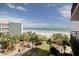Beautiful ocean view from balcony featuring palm trees, sandy beach and walking bridge at 2710 N Ocean Blvd. # 402, Myrtle Beach, SC 29577