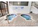 Enclosed hot tub area with brick flooring and tiled walls and stairs at 2710 N Ocean Blvd. # 402, Myrtle Beach, SC 29577